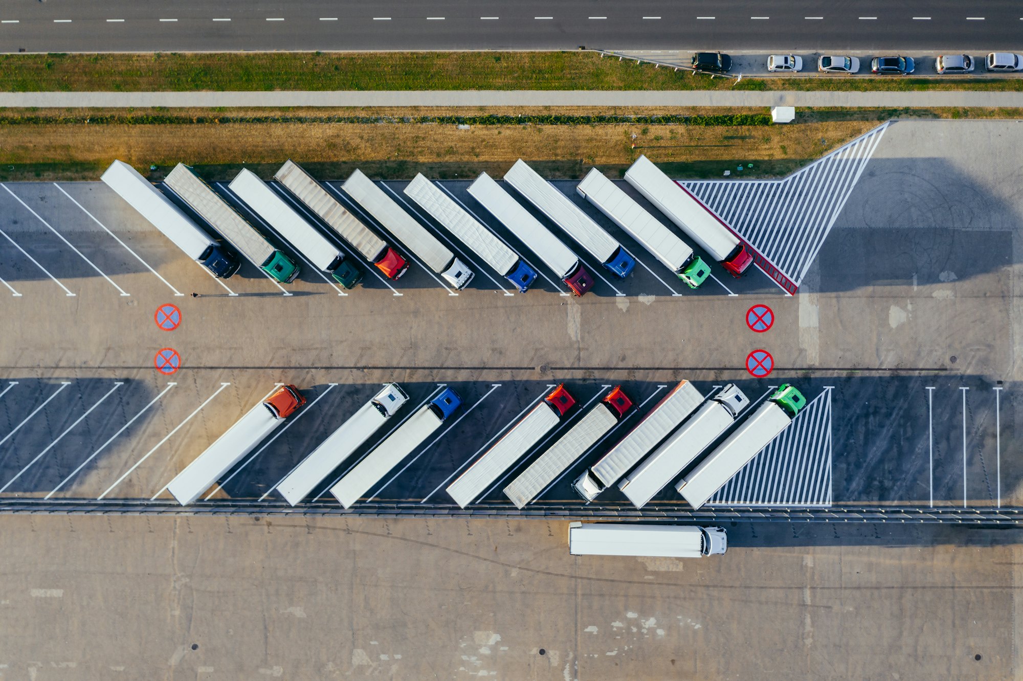 Row of freight trucks parked at a depot